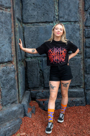 Adult wearing pumpkin socks featuring grinning jack-o'-lanterns